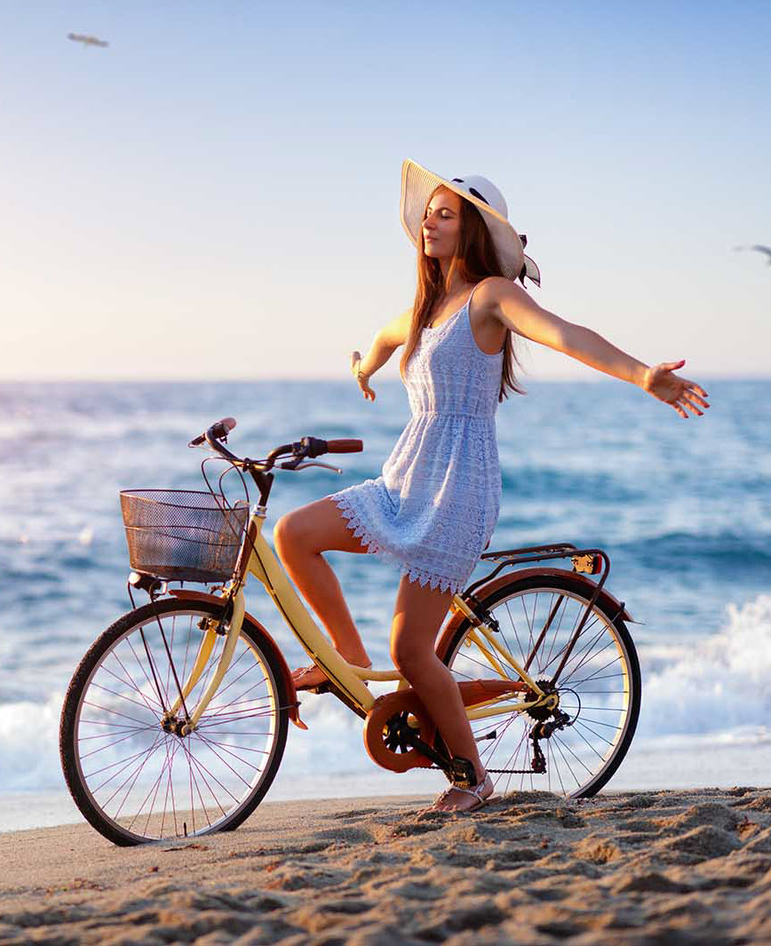 Two people jogging outdoors on a pathway surrounded by autumn leaves. The woman is wearing a purple jacket and pink leggings, while the man is wearing a blue jacket and dark pants.